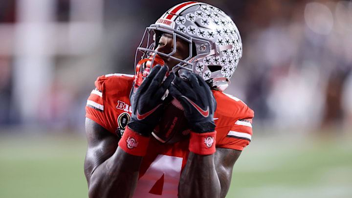 Dec 21, 2024; Columbus, Ohio, USA;  Ohio State Buckeyes wide receiver Jeremiah Smith (4) catches a touchdown during the third quarter against the Tennessee Volunteers at Ohio Stadium. Mandatory Credit: Joseph Maiorana-Imagn Images