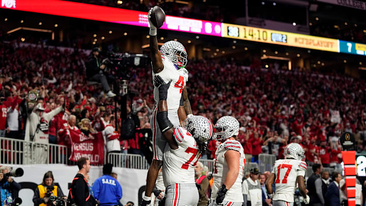 Ohio State Buckeyes wide receiver Jeremiah Smith (4) celebrates with offensive lineman Donovan Jackson (74) after a touchdown catch against Notre Dame Fighting Irish in the first quarter during the College Football Playoff National Championship at Mercedes-Benz Stadium in Atlanta on January 20, 2025.