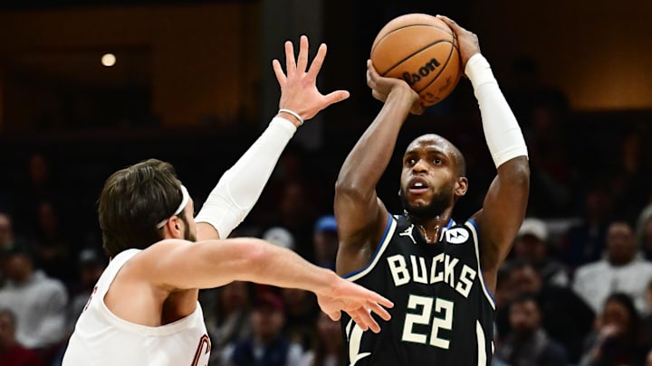 Dec 20, 2024; Cleveland, Ohio, USA; Milwaukee Bucks forward Khris Middleton (22) shoots over the defense of  Cleveland Cavaliers guard Max Strus (1) during the first half at Rocket Mortgage FieldHouse. Mandatory Credit: Ken Blaze-Imagn Images