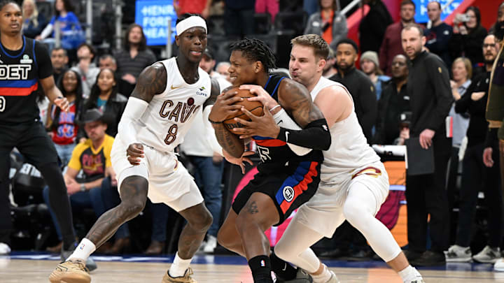 Feb 27, 2026; Detroit, Michigan, USA;  Cleveland Cavaliers guard Sam Merrill (5) ties up Detroit Pistons guard Marcus Sasser (25) for a jump ball as Cleveland Cavaliers guard Dennis Schroder (8) looks on in overtime at Little Caesars Arena. Mandatory Credit: Lon Horwedel-Imagn Images