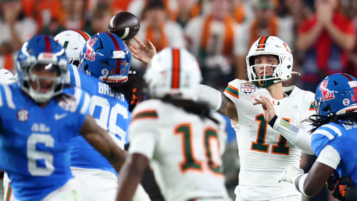 Miami Hurricanes quarterback Carson Beck (11) drops back to pass against the Mississippi Rebels in the first half during the 2026 Fiesta Bowl and semifinal game of the College Football Playoff at State Farm Stadium. Mandatory Credit: Mark J. Rebilas-Imagn Images