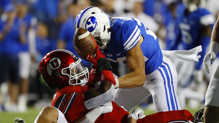 Sep 11, 2021; Provo, Utah, USA; Utah Utes running back Tavion Thomas (9) is stopped by Brigham Young Cougars linebacker Keenan Pili (41) defensive back Ammon Hannemann (22) in the third quarter at LaVell Edwards Stadium. Mandatory Credit: Jeffrey Swinger-Imagn Images