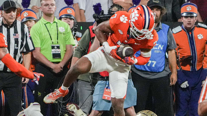 Nov 8, 2025; Clemson, South Carolina, USA; Clemson Tigers safety Khalil Barnes (7) intercepts a ball but was ruled out of bounds near Florida State Seminoles receiver Lawayne McCoy (7) during the second quarter  at Memorial Stadium. Mandatory Credit: Ken Ruinard - GREENVILLE NEWS-USA TODAY Network via Imagn Images