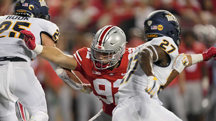 Sep 17, 2022; Columbus, Ohio, USA; Ohio State Buckeyes defensive end Caden Curry (92) goes up against Toledo Rockets safety Maxen Hook (25) and Toledo Rockets cornerback Quinyon Mitchell (27) during a college football game at Ohio Stadium. Mandatory Credit: Barbara Perenic-Imagn Images