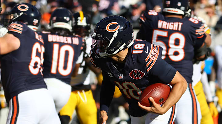 Nov 23, 2025; Chicago, Illinois, USA; Chicago Bears quarterback Caleb Williams (18) rushes the ball for a first down on fourth down during the second half at Soldier Field.