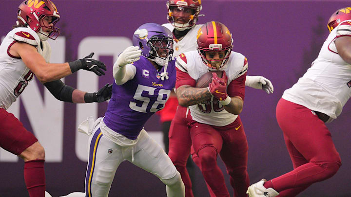 Dec 7, 2025; Minneapolis, Minnesota, USA; Washington Commanders running back Chris Rodriguez Jr. (36) rushes the ball against Minnesota Vikings linebacker Jonathan Greenard (58) during the first half at U.S. Bank Stadium. Mandatory Credit: Brad Rempel-Imagn Images