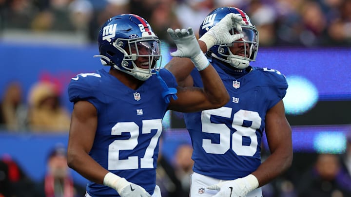 Dec 21, 2025; East Rutherford, New Jersey, USA; New York Giants inside linebacker Bobby Okereke (58) reacts with safety Tyler Nubin (27) after a defensive stop against the Minnesota Vikings during the first half at MetLife Stadium. 