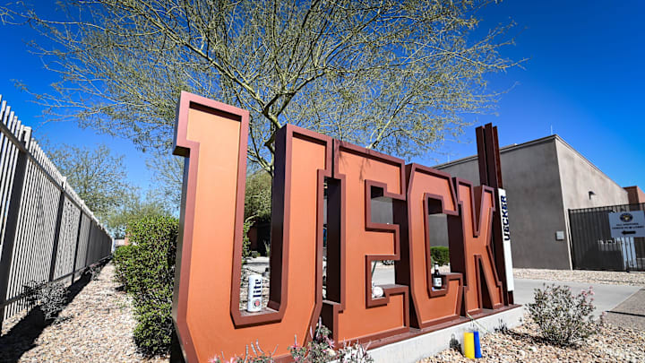 A tribute to late broadcaster Bob Uecker stands outside the stadium, adorned with beer and candles, Saturday, February 15, 2025, at the American Family Fields of Phoenix in Phoenix, Arizona.