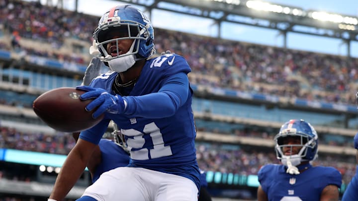 Dec 21, 2025; East Rutherford, New Jersey, USA; New York Giants cornerback Paulson Adebo (21) reacts after a turnover against the Minnesota Vikings during the first half at MetLife Stadium.  