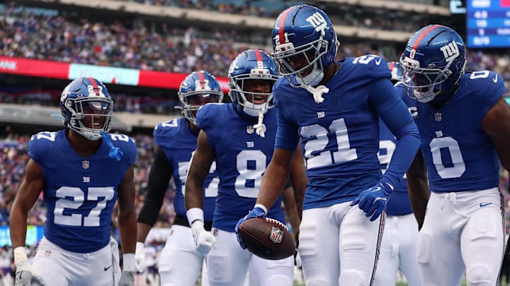Dec 21, 2025; East Rutherford, New Jersey, USA; New York Giants cornerback Paulson Adebo (21) reacts after a turnover against the Minnesota Vikings during the first half at MetLife Stadium. Mandatory Credit: Vincent Carchietta-Imagn Images