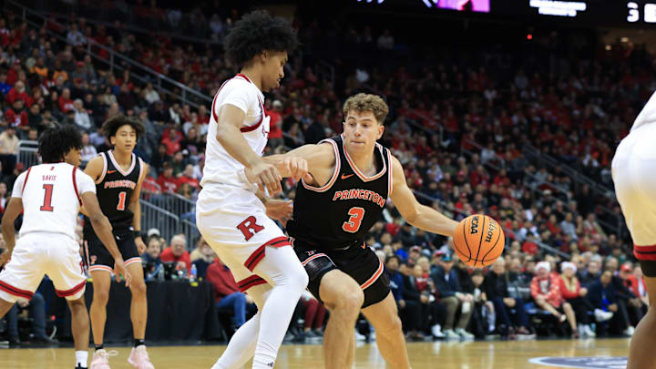 Dec 21, 2024; Newark, New Jersey, USA; Princeton Tigers forward Caden Pierce (3) dribbles to the net while being guarded by Rutgers Scarlet Knights guard Dylan Harper (2) during the second half at Prudential Center. Mandatory Credit: Tom Horak-Imagn Images