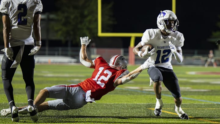Fishers senior Ryan Minns attempts to stop Brownsburg sophomore Branden Sharpe during the first half of an IHSAA varsity football game, Friday, Sept. 20, 2024, at Fishers High School.