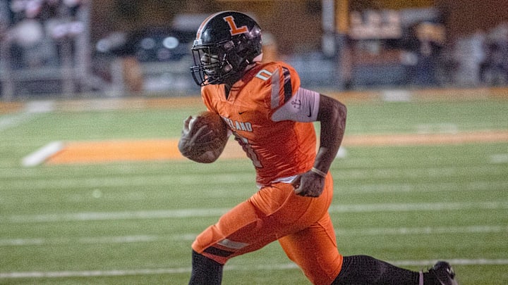 Lakeland running back Malik Morris runs for a touchdown against Lake Minneola on Friday night in the Class 4S, Region 2 final at Bryant Stadium.