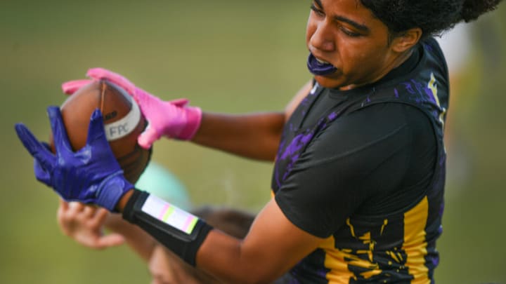 Fort Pierce Central’s Serenity Marte makes the reception in the end zone, on a pass from quarterback Adrienne Rivera, to score for Fort Pierce Central in the second quarter against Wellington during their flag football playoff game on Friday, May 3, 2024, in Fort Pierce. Central's quarterback Rivera followed up scoring the extra point, giving Central the lead through the third quarter 7-6. Wellington scored in the 4th quarter to win 12-7.