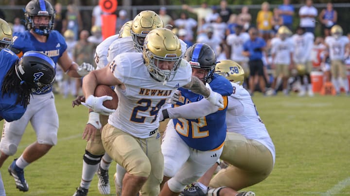 Cardinal Newman’s Phoenix Donghia, 24, sprints from John Carroll’s Manual Perez, 52, in the second quarter at John Carroll High School on Aug. 21, 2025, in Fort Pierce. Cardinal Newman’s Phoenix Donghia, 24, sprints from John Carroll’s Manual Perez, 52, in the second quarter at John Carroll High School on Aug. 21, 2025, in Fort Pierce.