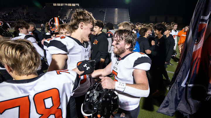 Grafton linebackers Sam Cameranesi (6) and Hank Doyle (84) celebrate their 34-31 overtime victory against Catholic Memorial in a WIAA Division 3 state semifinal Friday, November 14, 2025, at Oconomowoc High School in the Oconomowoc, Wisconsin. 