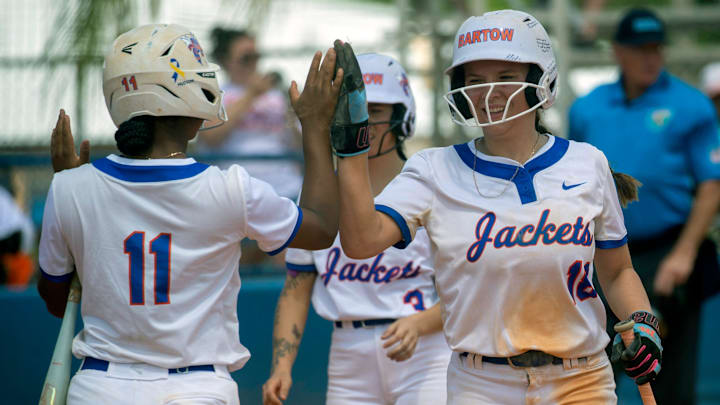 Bartow freshman Ava Haygood high-fives Bailee Ellis (11) after scoring against Plant City earlier this season in the championship game of the Bartow Home of Champions Softball Tournament at Bartow High School. The Yellow Jackets are 17-2 and ranked No. 7 in the High School on SI Florida Softball Top 25.