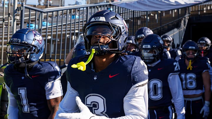 Nov 15, 2025; East Hartford, Connecticut, USA; The UConn Huskies head to the field for warm up before the start of the game against the Air Force Falcons at Pratt & Whitney Stadium at Rentschler Field. Mandatory Credit: David Butler II-Imagn Images