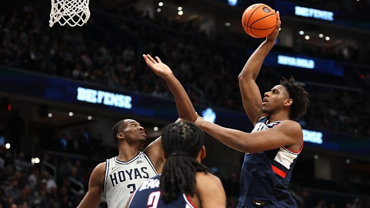 Jan 17, 2026; Washington, District of Columbia, USA; UConn Huskies forward Tarris Reed Jr. (5) takes a shot over Georgetown Hoyas center Vincent Iwuchukwu (3) during the second half at Capital One Arena. Mandatory Credit: Daniel Kucin Jr.-Imagn Images