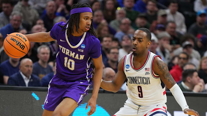Mar 20, 2026; Philadelphia, PA, USA; Furman Paladins guard Alex Wilkins (10) dribbles the ball past UConn Huskies guard Alec Millender (9) in the second half during a first round game of the men's 2026 NCAA Tournament at Xfinity Mobile Arena. Mandatory Credit: Kyle Ross-Imagn Images Mar 20, 2026; Philadelphia, PA, USA; Furman Paladins guard Alex Wilkins (10) dribbles the ball past UConn Huskies guard Alec Millender (9) in the second half during a first round game of the men's 2026 NCAA Tournament at Xfinity Mobile Arena. Mandatory Credit: Kyle Ross-Imagn Images