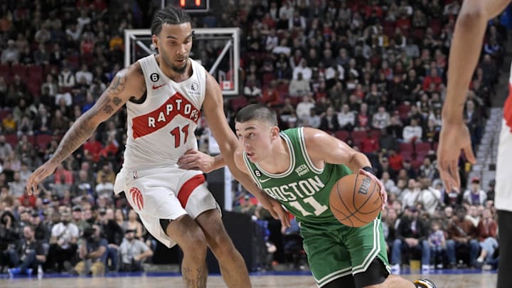 Oct 14, 2022; Montreal, Quebec, CAN; Boston Celtics guard Payton Pritchard (11) dribbles around Toronto Raptors guard Justin Champagnie (11) during the overtime at the Bell Centre. Mandatory Credit: Eric Bolte-Imagn Images