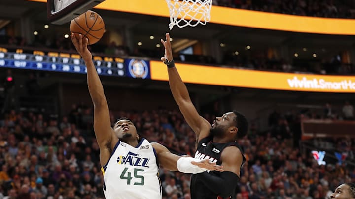 Dec 12, 2018; Salt Lake City, UT, USA; Utah Jazz guard Donovan Mitchell (45) drives to the hoop against Miami Heat guard Dwyane Wade (3) in the third quarter at Vivint Smart Home Arena. Mandatory Credit: Jeff Swinger-Imagn Images