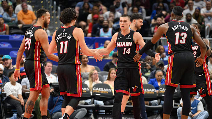 Mar 31, 2025; Washington, District of Columbia, USA; Miami Heat guard Tyler Herro (14) reacts with center Bam Adebayo (13), and guard Jaime Jaquez Jr. (11) during the third quarter against the Washington Wizards at Capital One Arena. Mandatory Credit: Reggie Hildred-Imagn Images Mar 31, 2025; Washington, District of Columbia, USA; Miami Heat guard Tyler Herro (14) reacts with center Bam Adebayo (13), and guard Jaime Jaquez Jr. (11) during the third quarter against the Washington Wizards at Capital One Arena. Mandatory Credit: Reggie Hildred-Imagn Images