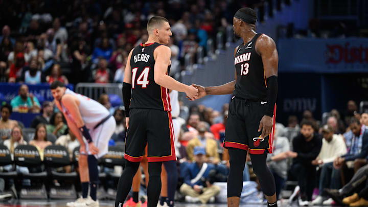 Mar 31, 2025; Washington, District of Columbia, USA; Miami Heat guard Tyler Herro (14) and center Bam Adebayo (13) react during the third quarter against the Washington Wizards at Capital One Arena. Mandatory Credit: Reggie Hildred-Imagn Images