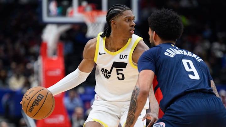 Mar 5, 2025; Washington, District of Columbia, USA; Utah Jazz forward Cody Williams (5) handles the ball against Washington Wizards forward Justin Champagnie (9) during the fourth quarter at Capital One Arena. Mandatory Credit: Reggie Hildred-Imagn Images
