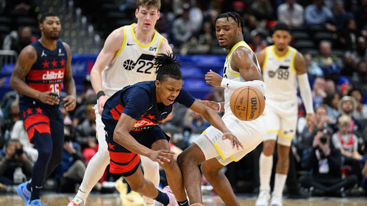Mar 5, 2025; Washington, District of Columbia, USA; Washington Wizards guard Bub Carrington (8) is fouled by Utah Jazz guard Isaiah Collier (13) during the fourth quarter at Capital One Arena. Mandatory Credit: Reggie Hildred-Imagn Images