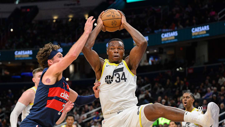 Mar 5, 2025; Washington, District of Columbia, USA; Utah Jazz center Oscar Tshiebwe (34) rebounds the ball against Washington Wizards forward Corey Kispert (24) during the fourth quarter at Capital One Arena. Mandatory Credit: Reggie Hildred-Imagn Images
