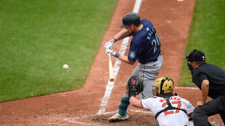 May 19, 2024; Baltimore, Maryland, USA; Seattle Mariners outfielder Luke Raley (20) hits a single during the sixth inning against the Baltimore Orioles at Oriole Park at Camden Yards. Mandatory Credit: Reggie Hildred-USA TODAY Sports