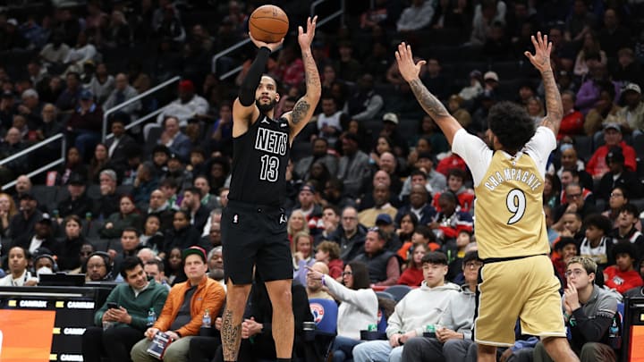 Jan 2, 2026; Washington, District of Columbia, USA; Brooklyn Nets guard Tyrese Martin (13) takes a shot over Washington Wizards forward Justin Champagnie (9) during the first half at Capital One Arena. Mandatory Credit: Daniel Kucin Jr.-Imagn Images
