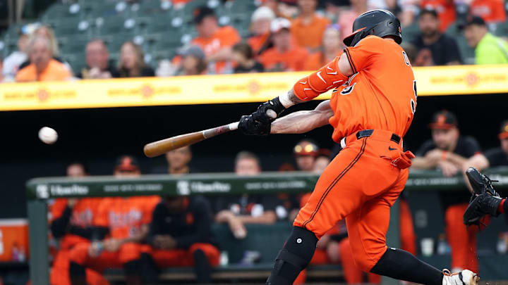 Apr 19, 2025; Baltimore, Maryland, USA; Baltimore Orioles outfielder Tyler O'Neill (9) hits a single during the eighth inning against the Cincinnati Reds at Oriole Park at Camden Yards. 