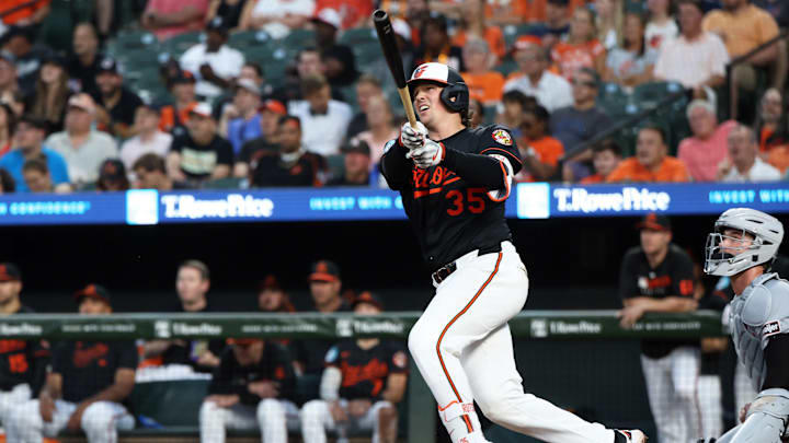 Jun 11, 2025; Baltimore, Maryland, USA; Baltimore Orioles catcher Adley Rutschman (35) hits a double during the seventh inning against the Detroit Tigers at Oriole Park at Camden Yards. Daniel Kucin Jr.-Imagn Images