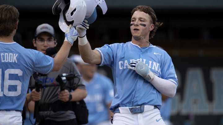 Jun 8, 2024; Chapel Hill, NC, USA; North Carolina Tar Heels Vance Honeycutt (7) and Casey Cook (16) celebrate a home run against the West Virginia Mountaineers during the DI Baseball Super Regional at Boshamer Stadium. 