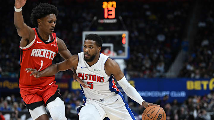 Nov 10, 2024; Detroit, Michigan, USA; Detroit Pistons guard Malik Beasley (5) drives up court past Houston Rockets forward Amen Thompson (1) in the fourth quarter at Little Caesars Arena. Mandatory Credit: Lon Horwedel-Imagn Images