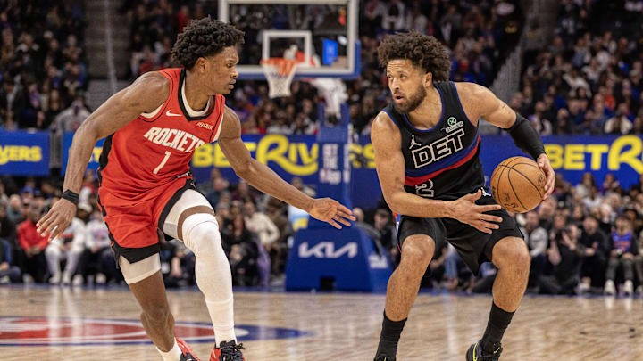 Jan 23, 2026; Detroit, Michigan, USA; Houston Rockets guard Amen Thompson (1) defends against Detroit Pistons guard Cade Cunningham (2) during the second half at Little Caesars Arena. Mandatory Credit: David Reginek-Imagn Images