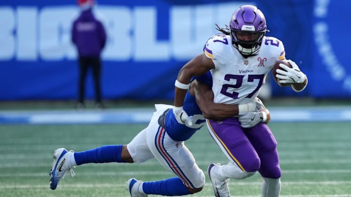 Dec 21, 2025; East Rutherford, New Jersey, USA; Minnesota Vikings running back Jordan Mason (27) rushes the ball against the New York Giants during the first half at MetLife Stadium. Mandatory Credit: Robert Deutsch-Imagn Images