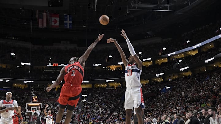 Oct 6, 2024; Montreal, Quebec, CAN; Washington Wizards power forward Alex Sarr (20) takes a jumps shot over Toronto Raptors forward Jonathan Mogbo (2) during the second quarter at the Bell Centre. Mandatory Credit: Eric Bolte-Imagn Images