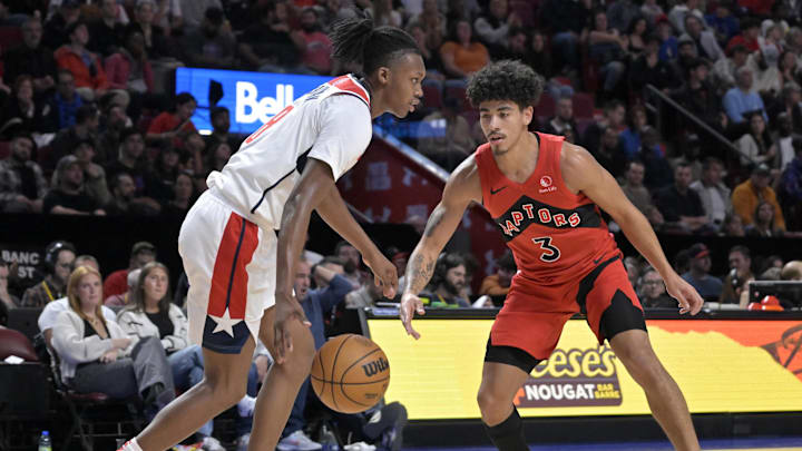 Oct 6, 2024; Montreal, Quebec, CAN; Washington Wizards guard Bub Carrington (8) dribbles and Toronto Raptors guard D.J. Carton (3) defends during the third quarter at the Bell Centre. Oct 6, 2024; Montreal, Quebec, CAN; Washington Wizards guard Bub Carrington (8) dribbles and Toronto Raptors guard D.J. Carton (3) defends during the third quarter at the Bell Centre.