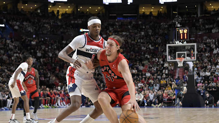 Oct 6, 2024; Montreal, Quebec, CAN;  Toronto Raptors power forward Kelly Olynyk (41) dribbles and Washington Wizards small forward Justin Champagnie (9) defends during the third quarter at the Bell Centre. Mandatory Credit: Eric Bolte-Imagn Images