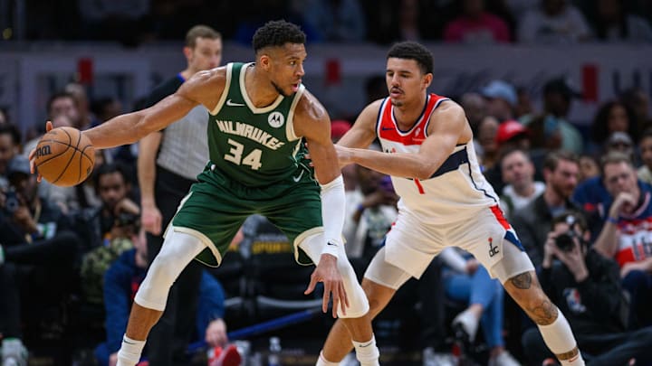 Apr 2, 2024; Washington, District of Columbia, USA; Milwaukee Bucks forward Giannis Antetokounmpo (34) dribbles while being defended by Washington Wizards guard Johnny Davis (1) during the third quarter at Capital One Arena. Mandatory Credit: Reggie Hildred-Imagn Images