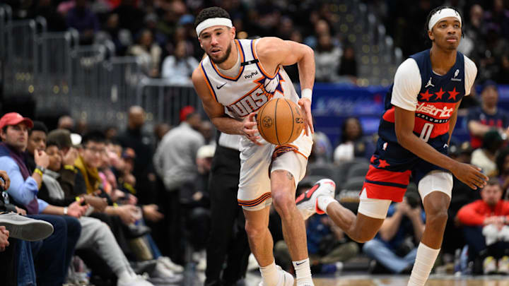 Jan 16, 2025; Washington, District of Columbia, USA; Phoenix Suns guard Devin Booker (1) saves the ball during the fourth quarter against the Washington Wizards at Capital One Arena. Mandatory Credit: Reggie Hildred-Imagn Images