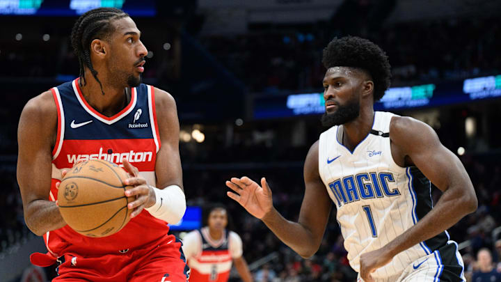 Mar 21, 2025; Washington, District of Columbia, USA; Washington Wizards forward Alex Sarr (20) handles the ball against Orlando Magic forward Jonathan Isaac (1) during the fourth quarter at Capital One Arena. Mandatory Credit: Reggie Hildred-Imagn Images