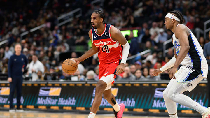 Mar 21, 2025; Washington, District of Columbia, USA; Washington Wizards forward Alex Sarr (20) handles the ball against Orlando Magic center Wendell Carter Jr. (34) during the third quarter at Capital One Arena. Mandatory Credit: Reggie Hildred-Imagn Images