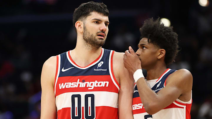 Mar 29, 2025; Washington, District of Columbia, USA; Washington Wizards forward Tristan Vukcevic (00) and Washington Wizards guard AJ Johnson (5) converse during the second half against the Brooklyn Nets at Capital One Arena. Mandatory Credit: Daniel Kucin Jr.-Imagn Images