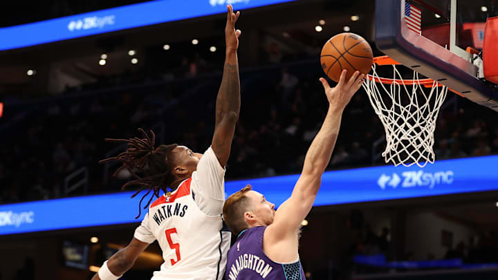 Feb 22, 2026; Washington, District of Columbia, USA; Charlotte Hornets guard Pat Connaughton (21) takes a shot over Washington Wizards guard Jamir Watkins (5) during the second half at Capital One Arena. Mandatory Credit: Daniel Kucin Jr.-Imagn Images