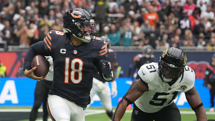 Oct 13, 2024; London, United Kingdom; Chicago Bears quarterback Caleb Williams (18) carries the ball against Jacksonville Jaguars linebacker Ventrell Miller (51) in the first half during an NFL International Series game at Tottenham Hotspur Stadium. Mandatory Credit: Kirby Lee-Imagn Images