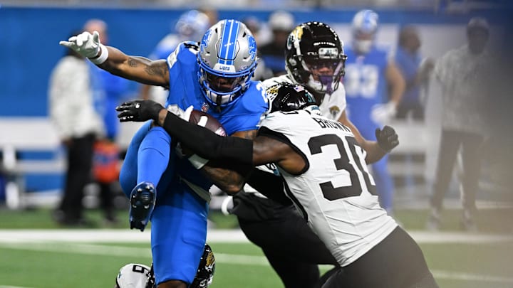 Nov 17, 2024; Detroit, Michigan, USA; Detroit Lions running back Jahmyr Gibbs (26) is tackled by Jacksonville Jaguars cornerback Montaric Brown (30) in the third quarter at Ford Field. Mandatory Credit: Lon Horwedel-Imagn Images